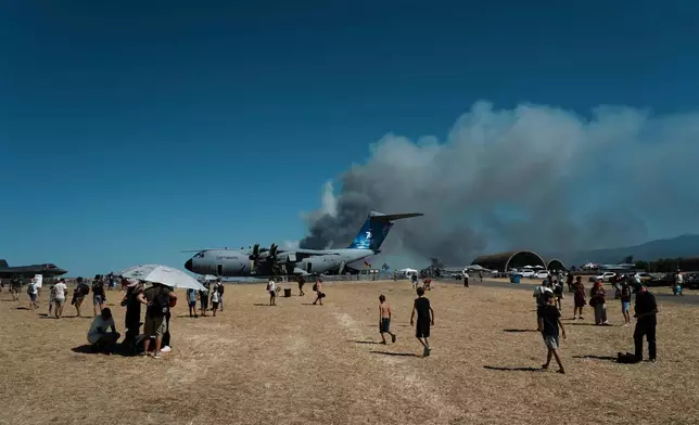 Smoke rises after a Hellenic Air Force F-4 Phantom fighter jet crashed, during the Athens Flying Week airshow at Tanagra Air Force Base, north of Athens, Greece, Saturday, Sept. 5, 2026. (AP Photo/Kallista Allaway)
