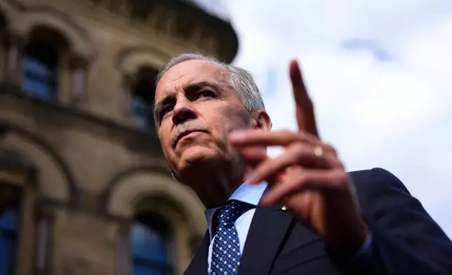 Canadian Prime Minister Mark Carney speaks with members of the media as he arrives at the Office of the Prime Minister and Privy Council in Ottawa, on Tuesday, Sept. 1, 2026. (Justin Tang/The Canadian Press via AP)