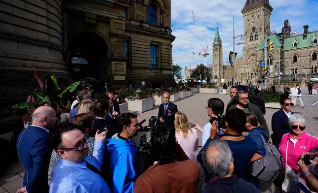 Prime Minister Mark Carney speaks to journalists as he arrives at the Office of the Prime Minister and Privy Council in Ottawa, Canada, Tuesday, Sept. 1, 2026. (Justin Tang/The Canadian Press via AP)