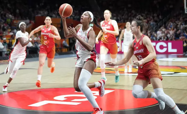 Angel Reese, of the United States, gies for a shot in front pf Hungary's Panka Dul during the Women's Basketball World Cup quarterfinal match between the United States and Hungary in Berlin, Thursday, Sept. 10, 2026. (AP Photo/Ebrahim Noroozi)