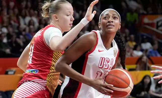 Hungary's Kinga Josepovits guards Angel Reese, of the United States, during the Women's Basketball World Cup quarterfinal match between the United States and Hungary in Berlin, Thursday, Sept. 10, 2026. (AP Photo/Ebrahim Noroozi)