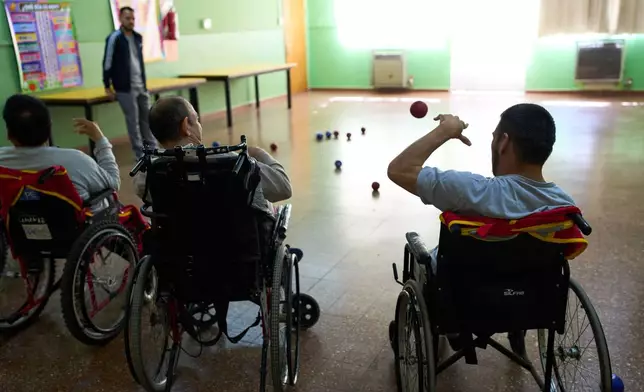 A resident practices tossing a ball during a physical therapy workshop in the Pequeño Cottolengo Don Orione, a home for people with disabilities that will be visited by Pope Leo XIV in November, in Buenos Aires, Argentina, Thursday, Sept. 24, 2026. (AP Photo/Rodrigo Abd)