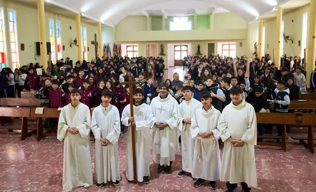 Faithful pose for a group photo in the church inside Pequeño Cottolengo Don Orione, a home for people with disabilities that will be visited by Pope Leo XIV in November, in Buenos Aires, Argentina, Thursday, Sept. 24, 2026. (AP Photo/Rodrigo Abd)