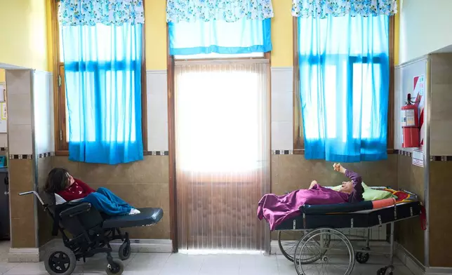 Residents gather in a communal area as they wait to fed at the Pequeño Cottolengo Don Orione, a home for people with disabilities that will be visited by Pope Leo XIV in November, in Buenos Aires, Argentina, Thursday, Sept. 24, 2026. (AP Photo/Rodrigo Abd)