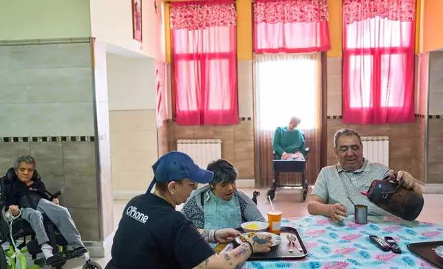 Residents gather in a communal space at the Pequeño Cottolengo Don Orione, a home for people with disabilities that will be visited by Pope Leo XIV in November, in Buenos Aires, Argentina, Thursday, Sept. 24, 2026. (AP Photo/Rodrigo Abd)