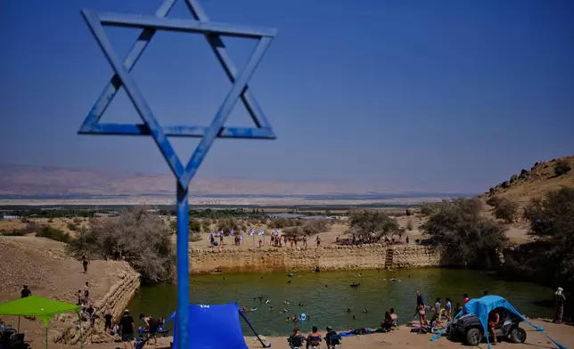 Israelis spend the day at the ancient archaeological site known as Herod's Pool, near the Israeli settlement of Petzael, which was filled with water designated for Palestinian farmland, in the Jordan Valley of the occupied West Bank, on June 19, 2026. (AP Photo/Ohad Zwigenberg)