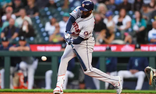 Houston Astros designated hitter Yordan Alvarez (44) hits an RBI single in the first inning of a baseball game against the Seattle Mariners, Tuesday, Sept. 22, 2026, in Seattle. (AP Photo/Kevin Ng)