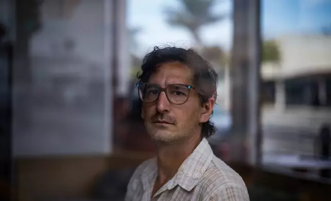 Jonathan Caravello, a lecturer at California State University Channel Islands, sits for a photo in Ventura, Calif., Friday, Aug. 28, 2026. (AP Photo/Jae C. Hong)
