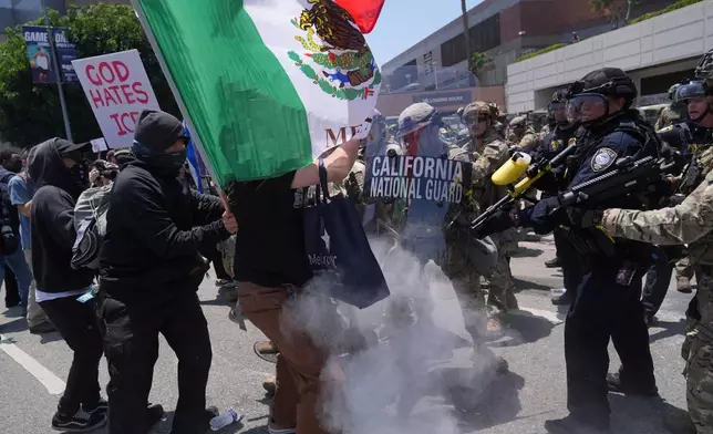 FILE - Protesters clash with authorities in downtown Los Angeles, June 8, 2025, following the night's immigration raid protest. (AP Photo/Jae Hong, File)