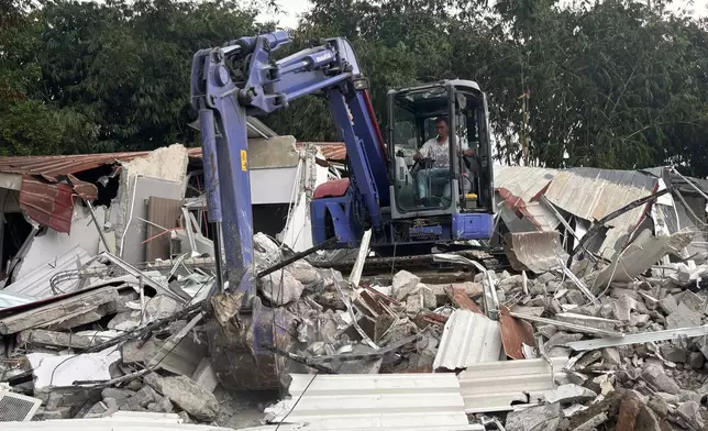 In this photo taken with a smartphone, a controversial luxury compound is razed after inspection inside Cibinong Penitentiary in Bogor, West Java, Indonesia, Wednesday, Sept. 30, 2026. (AP Photo/Fadlan Syam)