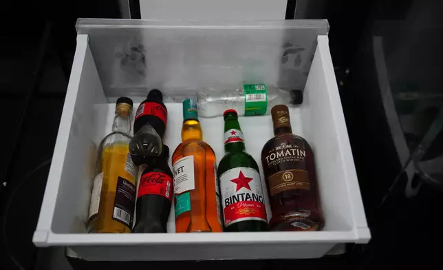 Bottles of alcoholic beverages are seen inside a refrigerator of a controversial luxury compound during an inspection by lawmakers to Cibinong Prison in Bogor, West Java, Indonesia, Wednesday, Sept. 30, 2026. (AP Photo/Tatan Syuflana)