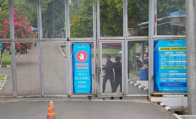 Soldiers stand near a gate of Cibinong Prison during an inspection by lawmakers of a controversial luxury compound in Bogor, West Java, Indonesia, Wednesday, Sept. 30, 2026. (AP Photo/Tatan Syuflana)