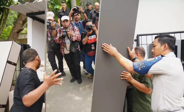 Workers remove furniture from a controversial luxury compound inside a penitentiary during an inspection by lawmakers to Cibinong Prison in Bogor, West Java, Indonesia, Wednesday, Sept. 30, 2026. (AP Photo/Tatan Syuflana)