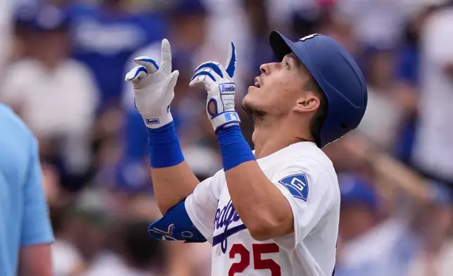 Los Angeles Dodgers' Tommy Edman gestures as he scores after hitting a solo home run during the sixth inning of a baseball game against the San Francisco Giants, Sunday, Sept. 20, 2026, in Los Angeles. (AP Photo/Mark J. Terrill)