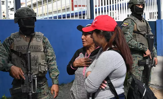 Women seek information about the expected arrival of their relatives who were aboard the Maria Candelaria, a vessel intercepted two days prior by U.S. authorities on suspicion of alleged drug trafficking, at the port in Manta, Ecuador, Monday, Sept. 7, 2026. (AP Photo/Ariel Ochoa)