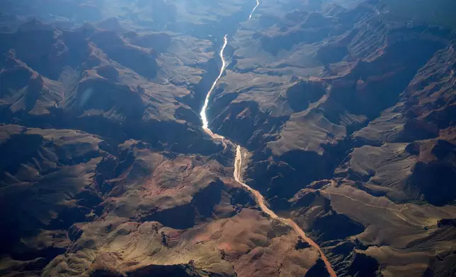 Bright Angel Canyon, middle left, the scene of flash floods, meets with the Colorado River in the Grand Canyon, Monday, Aug. 31, 2026, at Grand Canyon National Park, Ariz. (AP Photo/John Locher)
