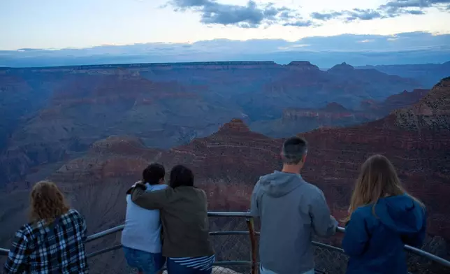 People stand at the rim of the Grand Canyon, Monday, Aug. 31, 2026, in Grand Canyon National Park, Ariz. (AP Photo/John Locher)