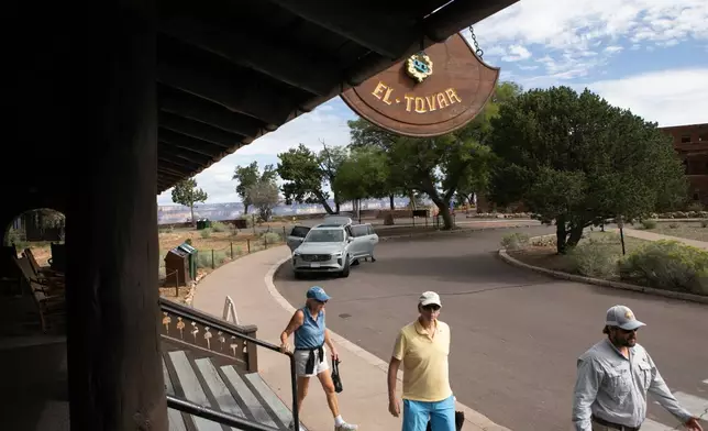 Tourists check out of the El Tovar Hotel as lodging along the rim of the canyon was shut down due to flooding, Monday, Aug. 31, 2026 at Grand Canyon National Park, Ariz. (AP Photo/Josh Biggs)