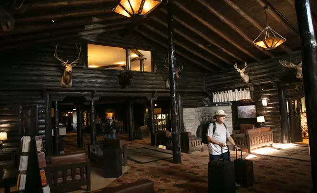 Tourists check out of the El Tovar Hotel as lodging along the rim of the canyon was shut down due to flooding, Monday, Aug. 31, 2026 at Grand Canyon National Park, Ariz. (AP Photo/Josh Biggs)