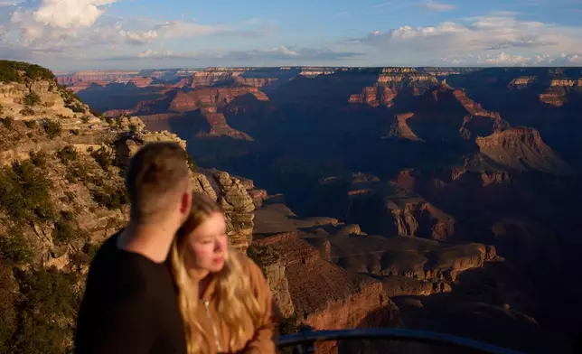 People stand at the rim of the Grand Canyon, Monday, Aug. 31, 2026, in Grand Canyon National Park, Ariz. (AP Photo/John Locher)