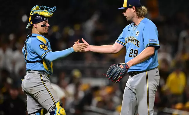 Milwaukee Brewers pitcher Trevor Megill is congratulated by catcher William Contreras after the Brewers defeated the Pittsburgh Pirates in a baseball game, Tuesday, Sept. 15, 2026, in Pittsburgh. (AP Photo/David Dermer)