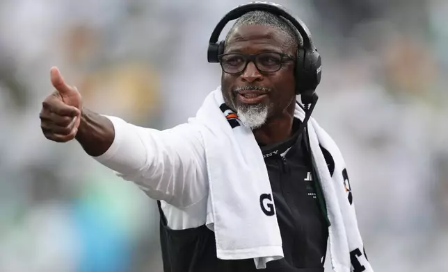 New York Jets head coach Aaron Glenn gives a thumbs up on the field during an NFL football game against the Green Bay Packers in East Rutherford, N.J., Sunday, Sept. 20, 2026. (AP Photo/Adam Hunger)