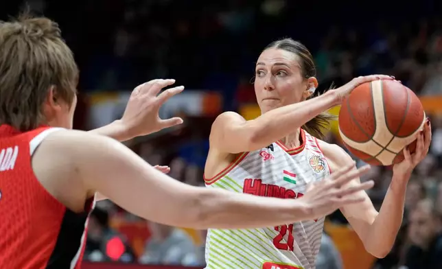 Hungary's Reka Lelik, right, and Japan's Maki Takada in action during the Women's Basketball World Cup qualification playoff between Hungary and Japan in Berlin, Tuesday Sept. 8, 2026. (AP Photo/Ebrahim Noroozi)