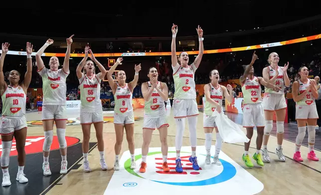 Hungary players celebrate defeating Japan after the Women's Basketball World Cup qualification playoff between Hungary and Japan in Berlin, Tuesday Sept. 8, 2026. (AP Photo/Ebrahim Noroozi)