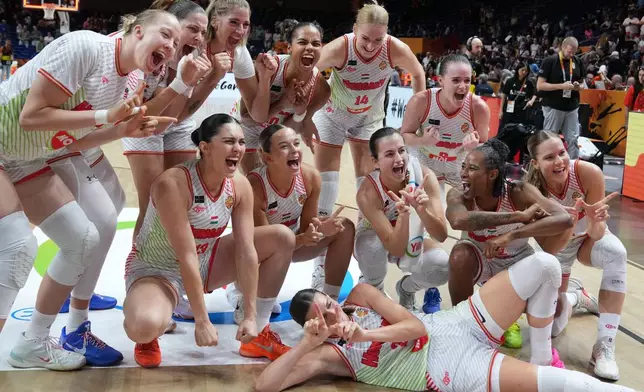 Hungary players celebrate defeating Japan after the Women's Basketball World Cup qualification playoff between Hungary and Japan in Berlin, Tuesday Sept. 8, 2026. (AP Photo/Ebrahim Noroozi)