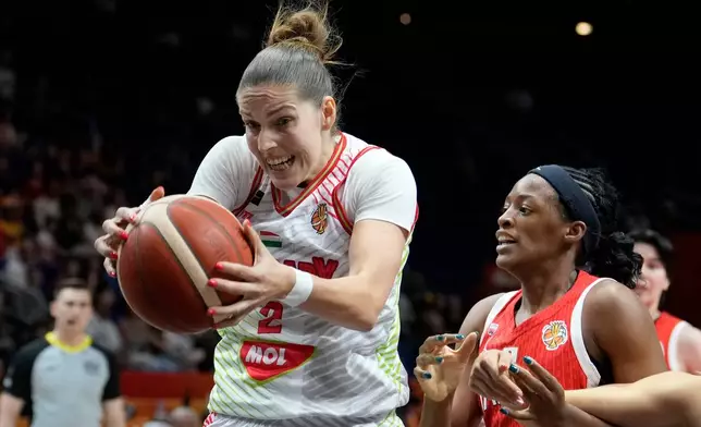 Hungary's Virag Takacs-Kiss, left, and Japan's Stephanie Mawuli in action during the Women's Basketball World Cup qualification playoff between Hungary and Japan in Berlin, Tuesday Sept. 8, 2026. (AP Photo/Ebrahim Noroozi)