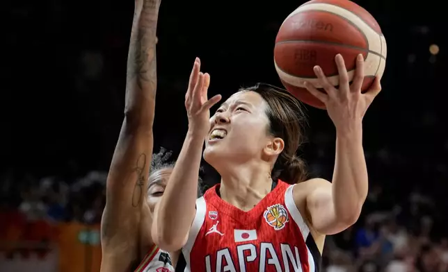 Japan's Mai Yamamoto, right, and Hungary's Yvonne Turner in action during the Women's Basketball World Cup qualification playoff between Hungary and Japan in Berlin, Tuesday Sept. 8, 2026. (AP Photo/Ebrahim Noroozi)