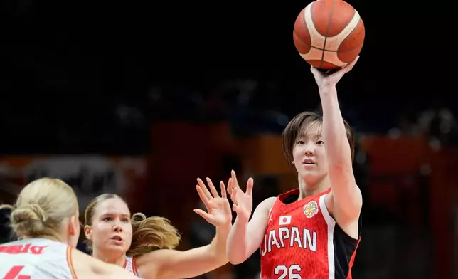 Japan's Kokoro Tanaka aims to shoot during the Women's Basketball World Cup qualification playoff between Hungary and Japan in Berlin, Tuesday Sept. 8, 2026. (AP Photo/Ebrahim Noroozi)