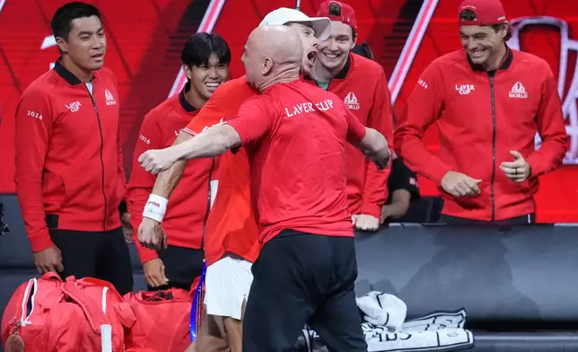 Team World's Alex De Minaur celebrates with Team World captain Andre Agassi after beating Team Europe's Alexander Zverev in a Laver Cup tennis tournament match in London, Saturday, Sept. 26, 2026. (AP Photo/Maja Smiejkowska)