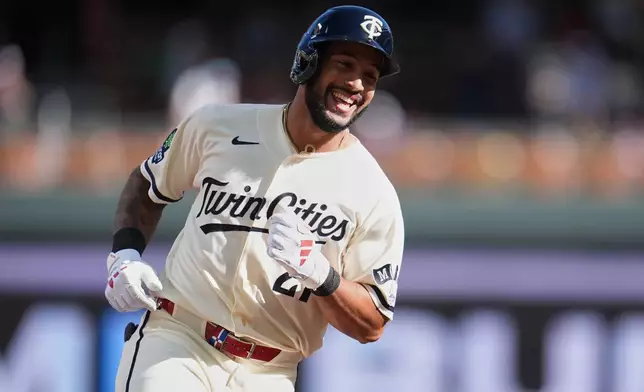 Minnesota Twins' Emmanuel Rodriguez (21) runs the bases after hitting a solo home run for his first-career hit during his MLB debut in the third inning of a baseball game in Minneapolis, Saturday, Sept. 12, 2026. (AP Photo/Abbie Parr)