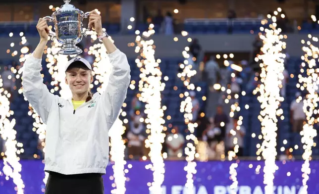 Elena Rybakina, of Kazakhstan, holds up her trophy after winning the women's singles final of the U.S. Open tennis championships against Aryna Sabalenka, of Belarus, Saturday, Sept. 12, 2026, in New York. (AP Photo/Adam Hunger)