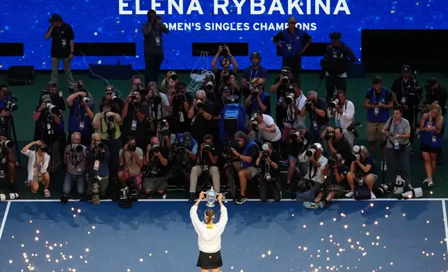 Elena Rybakina, of Kazakhstan, holds the trophy after she won the women's singles final of the U.S. Open tennis championships against Aryna Sabalenka, of Belarus, Saturday, Sept. 12, 2026, in New York. (AP Photo/Yuki Iwamura)