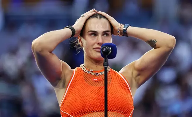 Aryna Sabalenka, of Belarus, reacts as she speaks following her lose to Elena Rybakina, of Kazakhstan, in the women's singles final of the U.S. Open tennis championships Saturday, Sept. 12, 2026, in New York. (AP Photo/Adam Hunger)