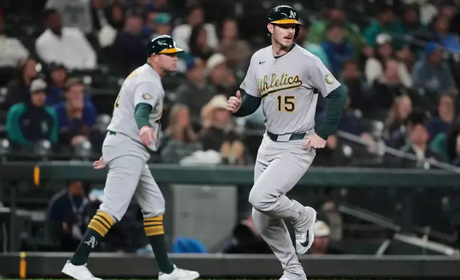 Athletics' Jonah Heim runs home to score on an RBI double from Jeff McNeil during the ninth inning of a baseball game against the Seattle Mariners, Thursday, Sept. 3, 2026, in Seattle. (AP Photo/Lindsey Wasson)