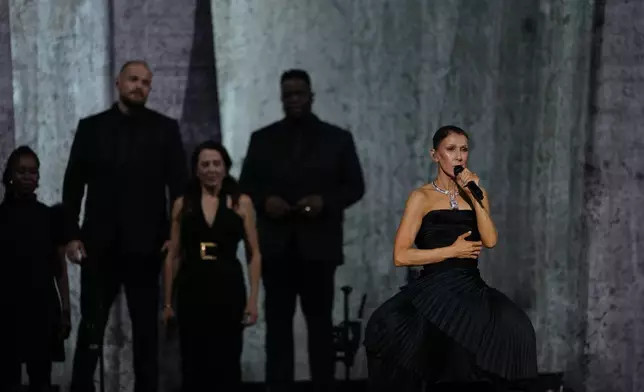 Singer Celine Dion performs during the opening concert of her "Celine Dion Paris 2026" residency at the Plenitude Arena in Nanterre, France, outside Paris, Saturday, Sept. 12, 2026. (AP Photo/Aurelien Morissard)