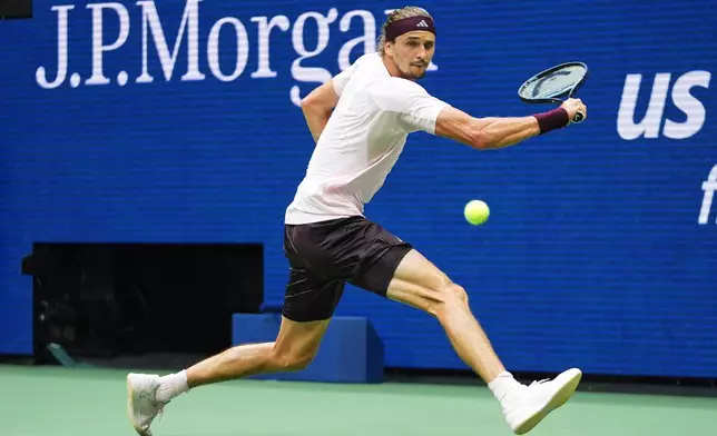 Alexander Zverev, of Germany, reaches to return the ball to Ben Shelton, of the United States, during the men's singles final of the U.S. Open tennis championships Sunday, Sept. 13, 2026, in New York. (AP Photo/Frank Franklin II)