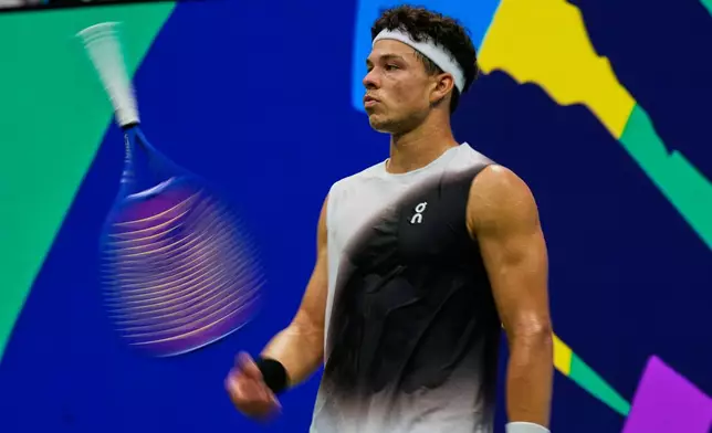 Ben Shelton, of the United States, spins his racket during the men's singles final of the U.S. Open tennis championships against Alexander Zverev, of Germany, Sunday, Sept. 13, 2026, in New York. (AP Photo/Frank Franklin II)