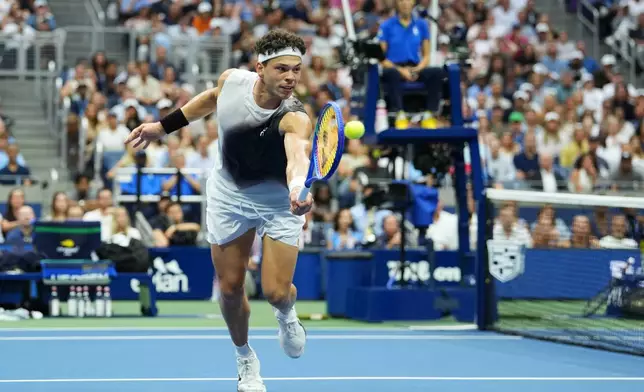 Ben Shelton, of the United States, returns the ball to Alexander Zverev, of Germany, during the men's singles final of the U.S. Open tennis championships Sunday, Sept. 13, 2026, in New York. (AP Photo/Kirsty Wigglesworth)