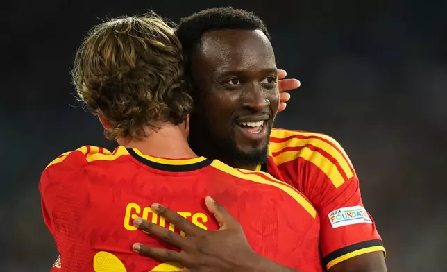 Belgium's Dodi Lukebakio celebrates with Mika Godts, left, after scoring his side's second goal during the Nations League soccer match between Italy and Belgium in Rome, Friday, Sept. 25, 2026. (AP Photo/Andrew Medichini)