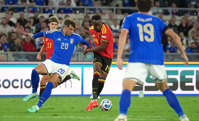 Belgium's Dodi Lukebakio, center, avoids Italy's Daniel Maldini to shoot and score his side's second goal during the Nations League soccer match between Italy and Belgium in Rome, Friday, Sept. 25, 2026. (AP Photo/Andrew Medichini)