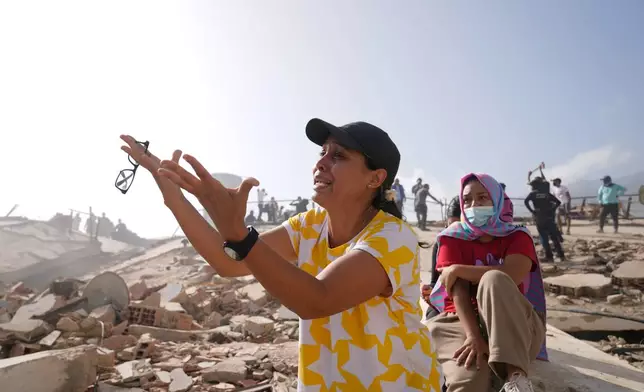 FILE - People search for missing relatives at the collapsed building where they lived, two days after earthquakes struck La Guaira, Venezuela, June 26, 2026. (AP Photo/Ariana Cubillos, File)