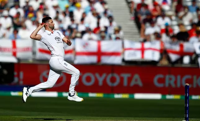 FILE - England's Mark Wood bowls a delivery during the first Ashes cricket test match between Australia and England in Perth, Friday, Nov. 21, 2025.(AP Photo/Gary Day, File)