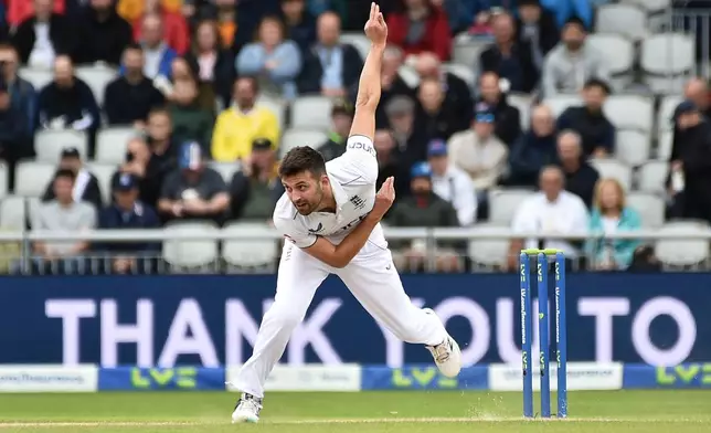 FILE - England's Mark Wood bowls a delivery during the fourth day of the fourth Ashes Test match between England and Australia at Old Trafford, Manchester, England, Saturday, July 22, 2023. (AP Photo/Rui Vieira, File)