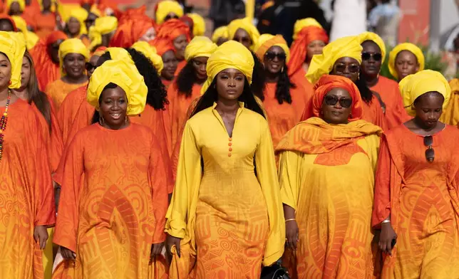 Women take part in a procession during an Olympic torch lighting ceremony, ahead of the Dakar 2026 Youth Olympic Games, in Dakar, Senegal, Saturday, Sept. 12, 2026. (AP Photo/Sylvain Cherkaoui)