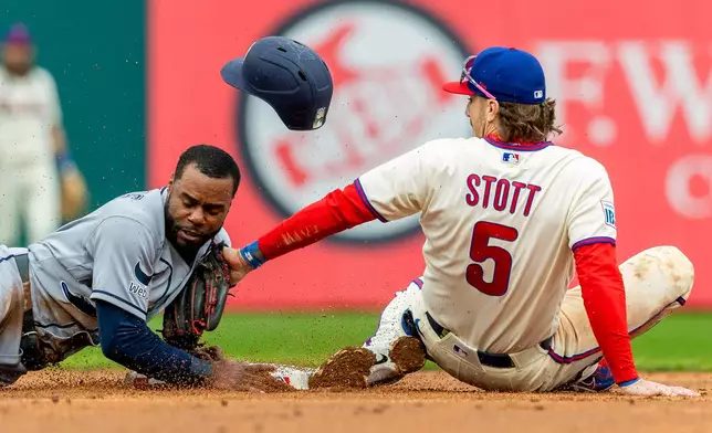 Tampa Bay Rays' Cedric Mullins, left, is safe at second before Philadelphia Phillies second baseman Bryson Stott (5) can tag him out in the fifth inning of a baseball game Sunday, Sept. 27, 2026, in Philadelphia. (AP Photo/Laurence Kesterson)