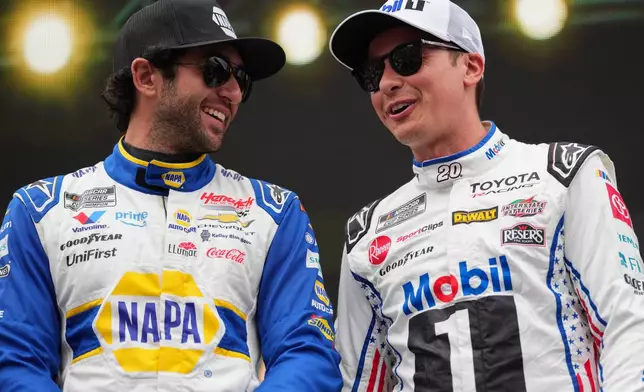 Chase Elliott, left, and Christopher Bell, right, interact prior to a NASCAR Cup Series auto race Sunday, Sept. 6, 2026, in Darlington, S.C. (AP Photo/Matt Kelley)